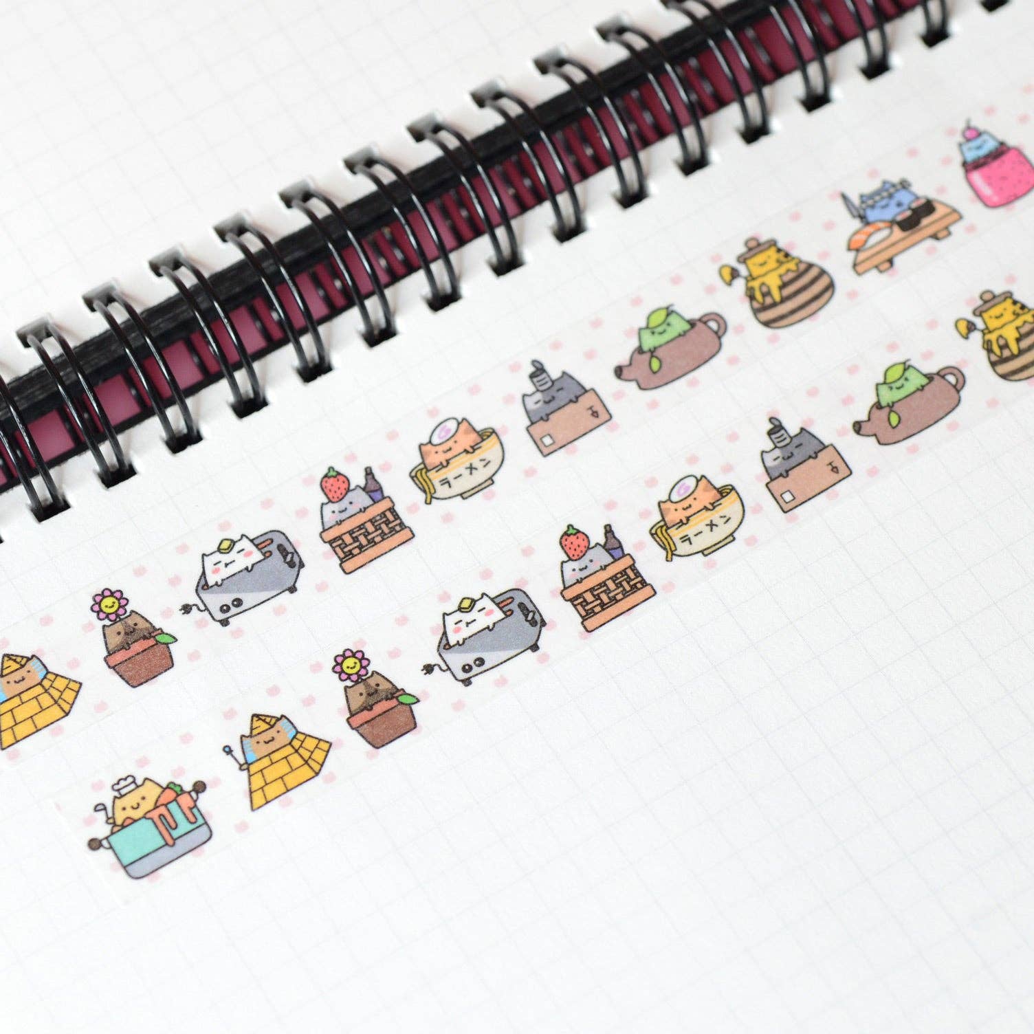 Sticker sheet with cute robot and cake designs on a notebook page.