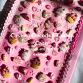Pink custom decoden tablet case with various decorative elements on a light gray background