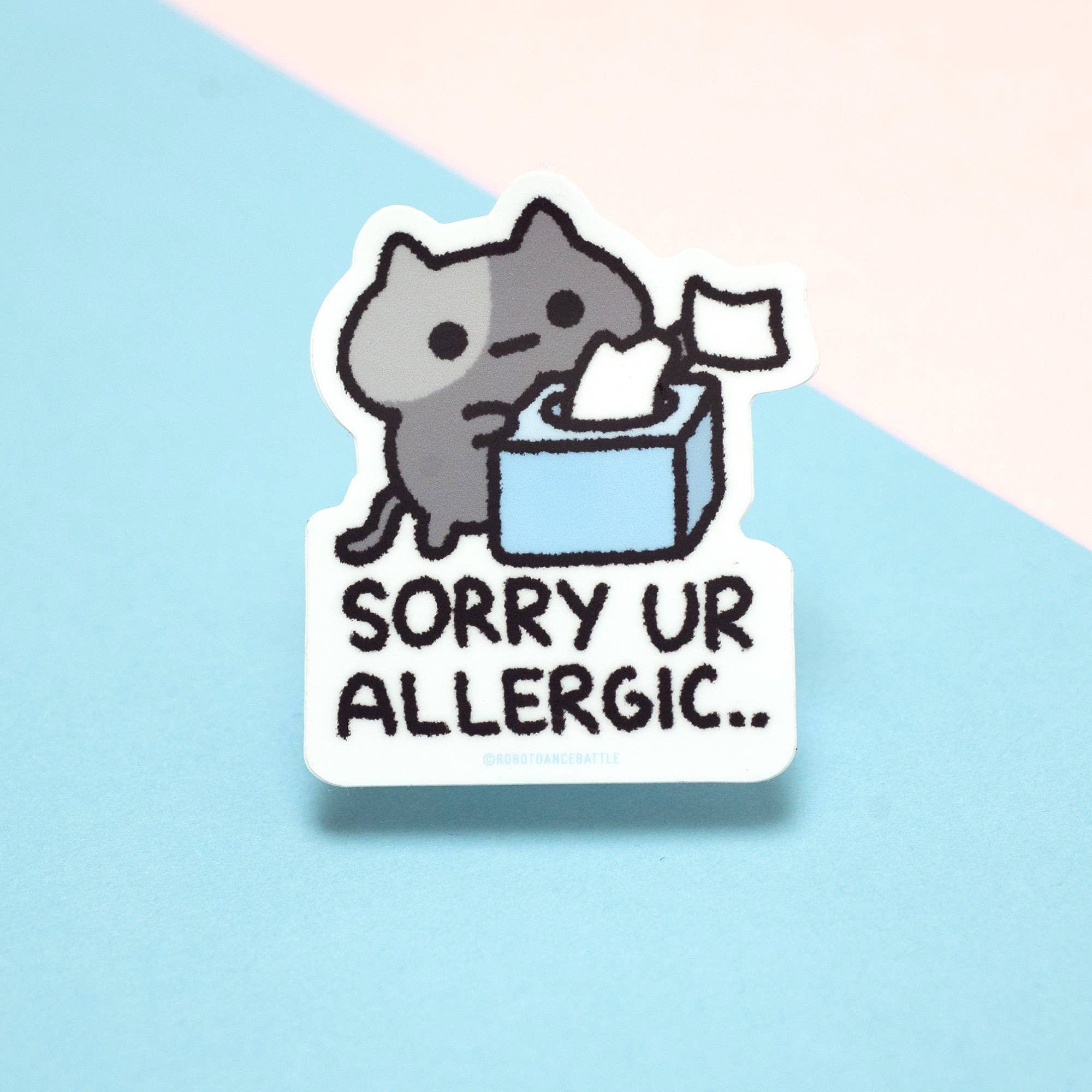 Sticker with a cat holding tissues and text 'Sorry UR ALLERGIC.' on a light blue background