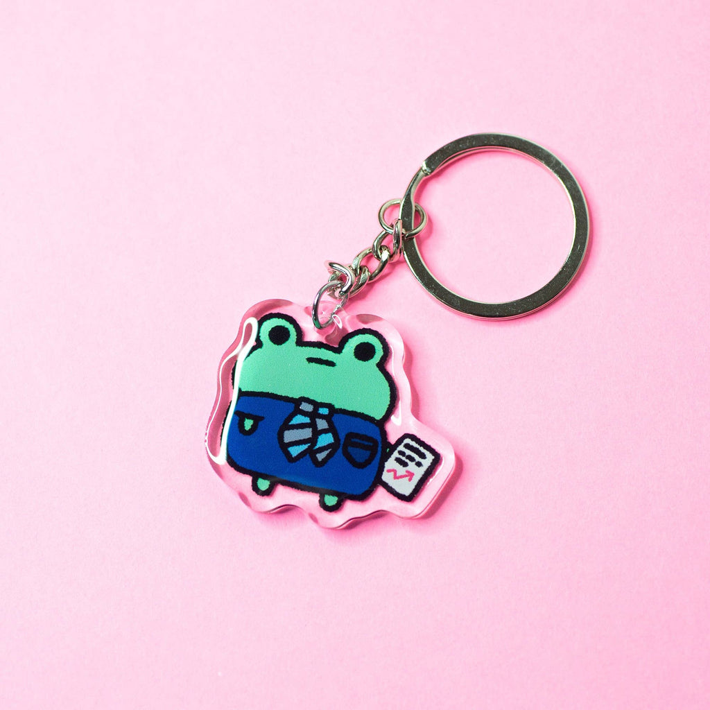 Keychain with a cartoon frog design on a pink background