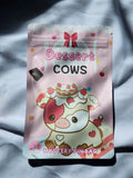 Packaged dessert with cow design on a gray fabric background