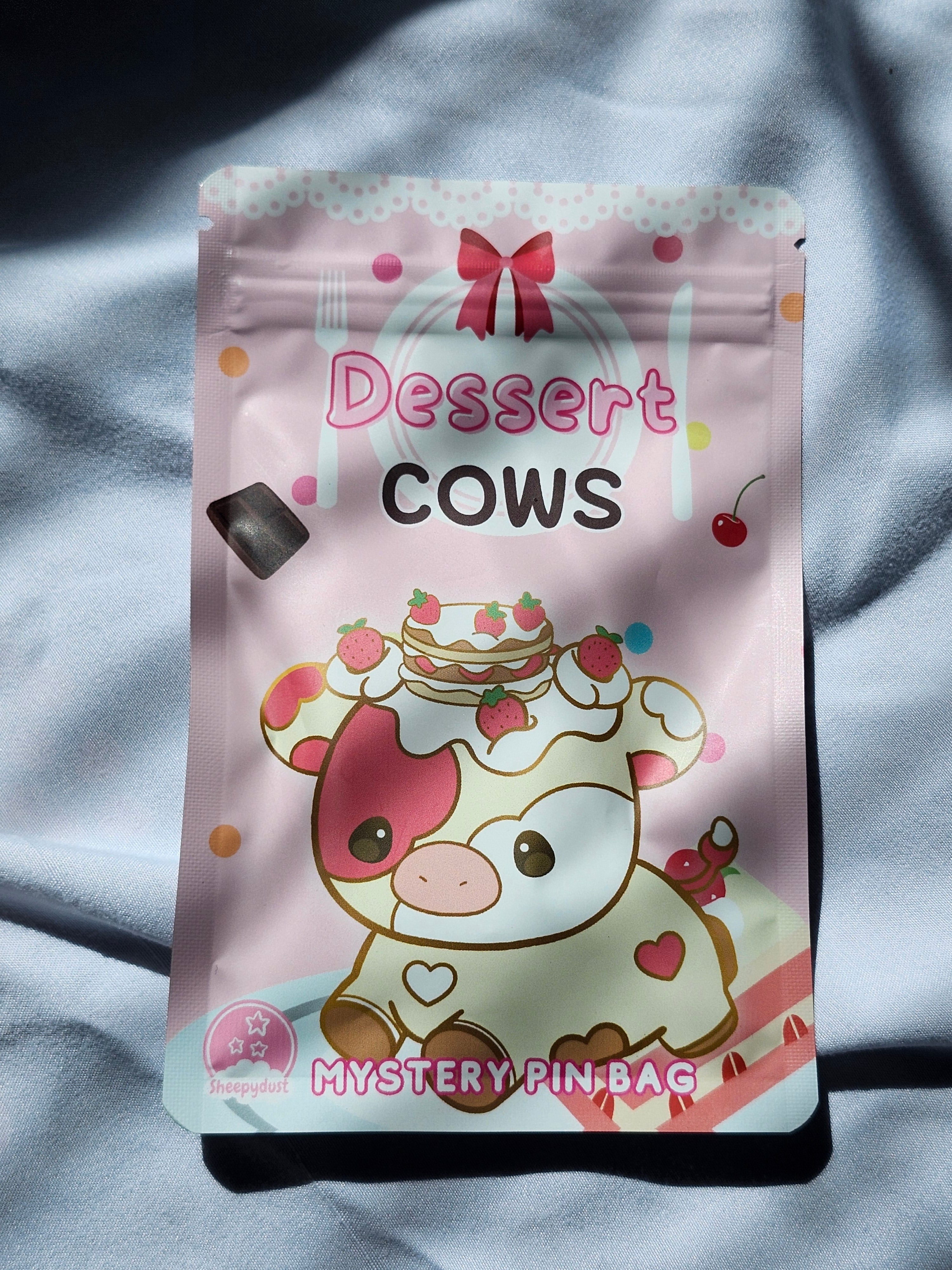 Packaged dessert with cow design on a gray fabric background
